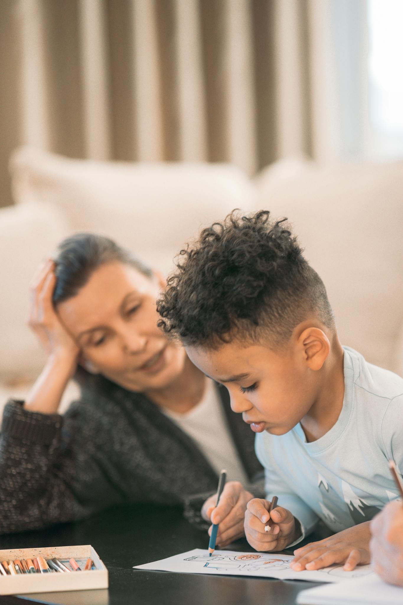 A grandmother and grandson enjoying drawing together at home, capturing a warm family moment.